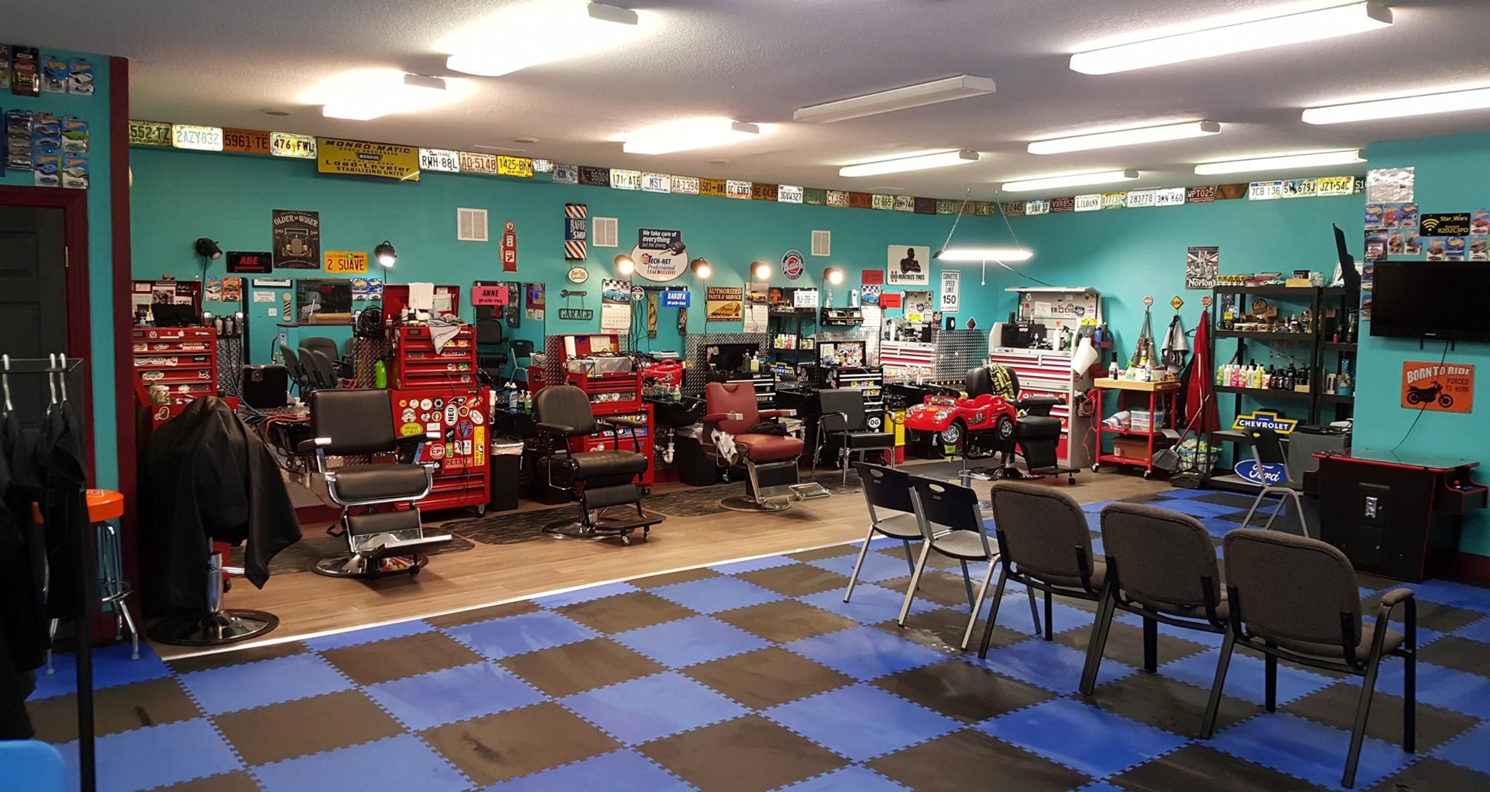 Barber chairs and colorful workstations inside The Chop Shop