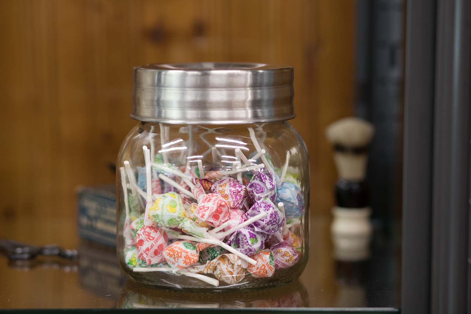 A jar of lollipops on the counter at Skyland Barber Shop